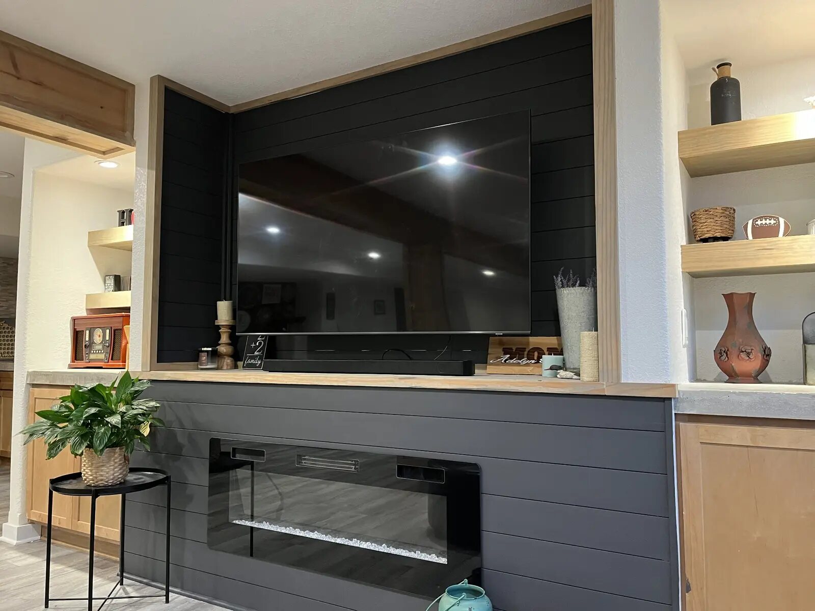 Custom black fireplace and television feature wall
