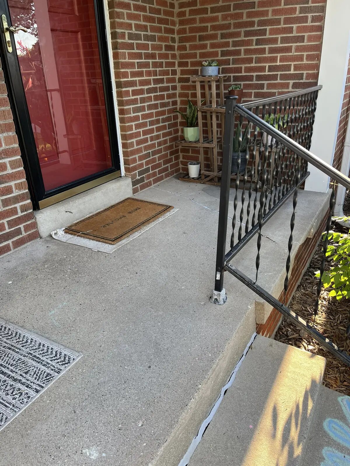 Original concrete porch and metal railing